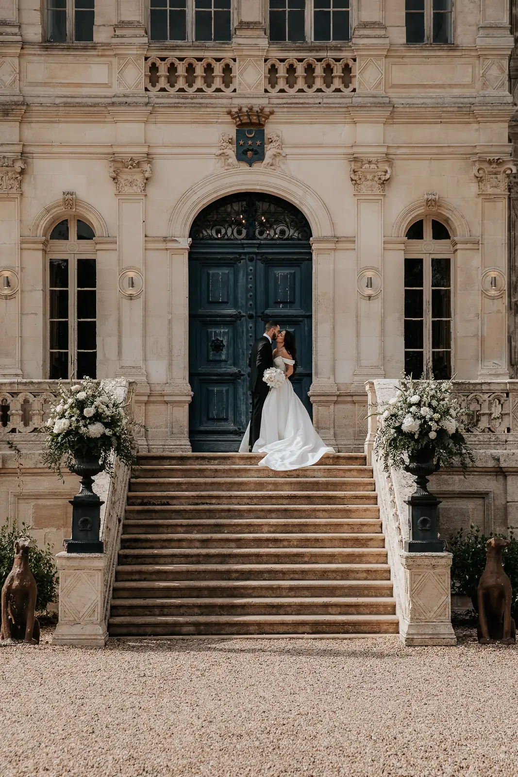 A bride in front of the blue door and the front steps