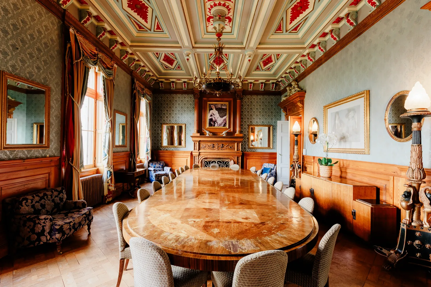 The grand dining room, its table and painted ceiling
