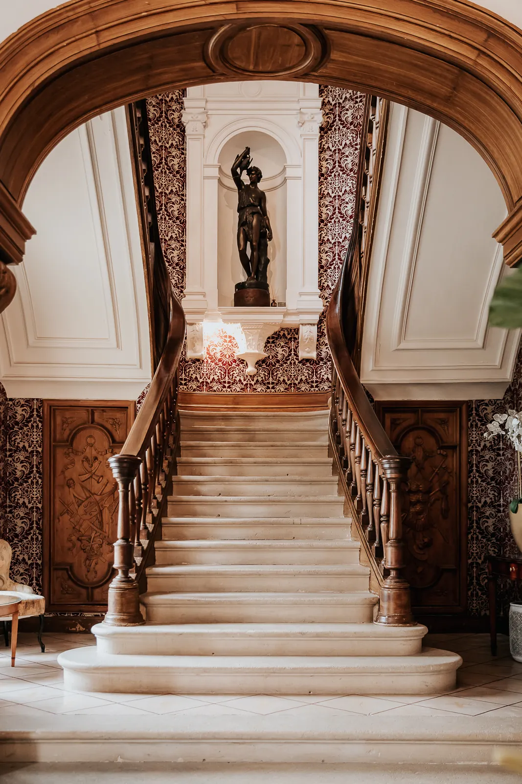 The staircase of honour and its statue in the niche
