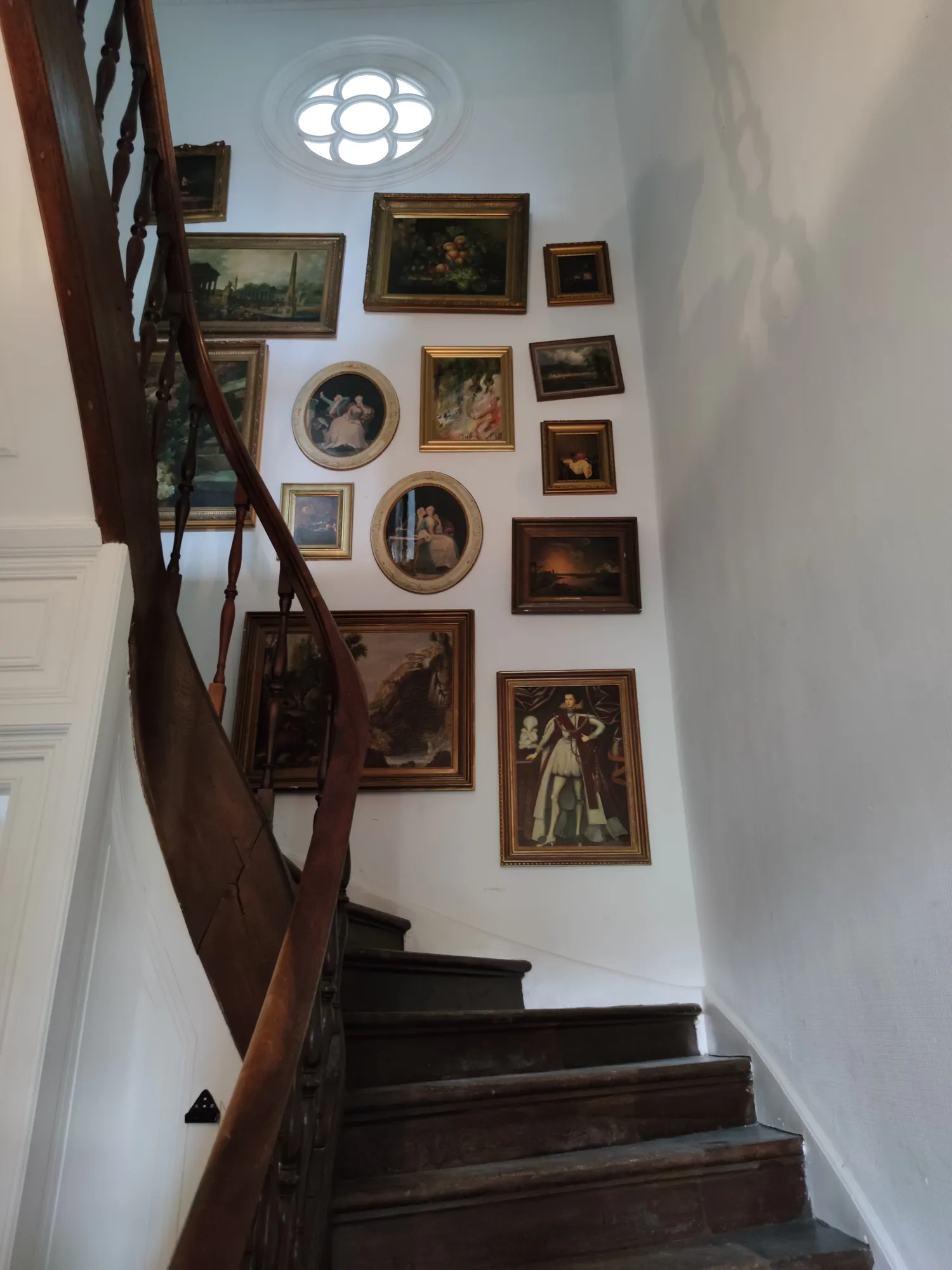The staircase and its wall of framed pictures