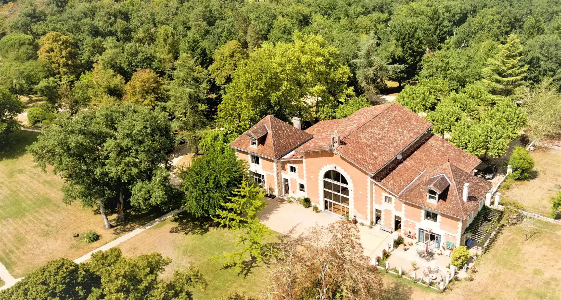 The brick reception hall and the estate seen from the air
