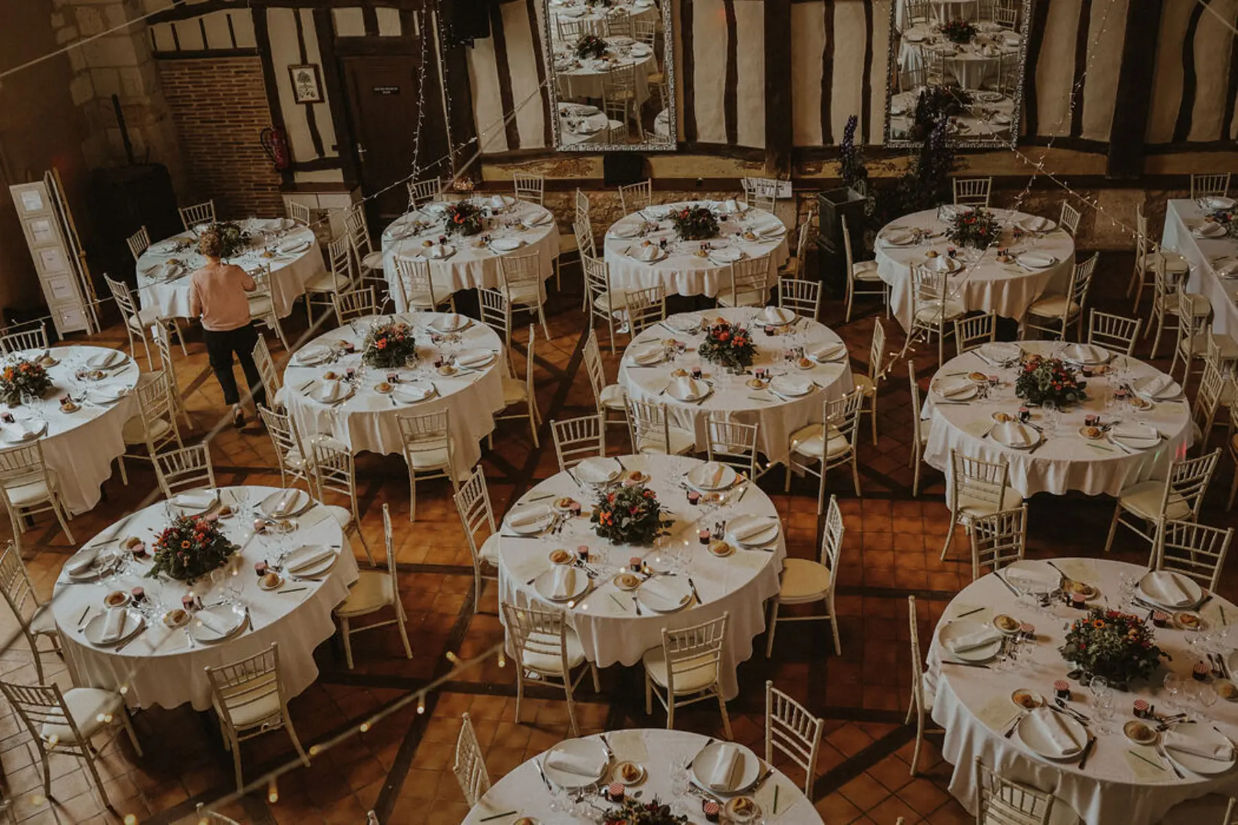 Round tables laid for dinner, seen from above