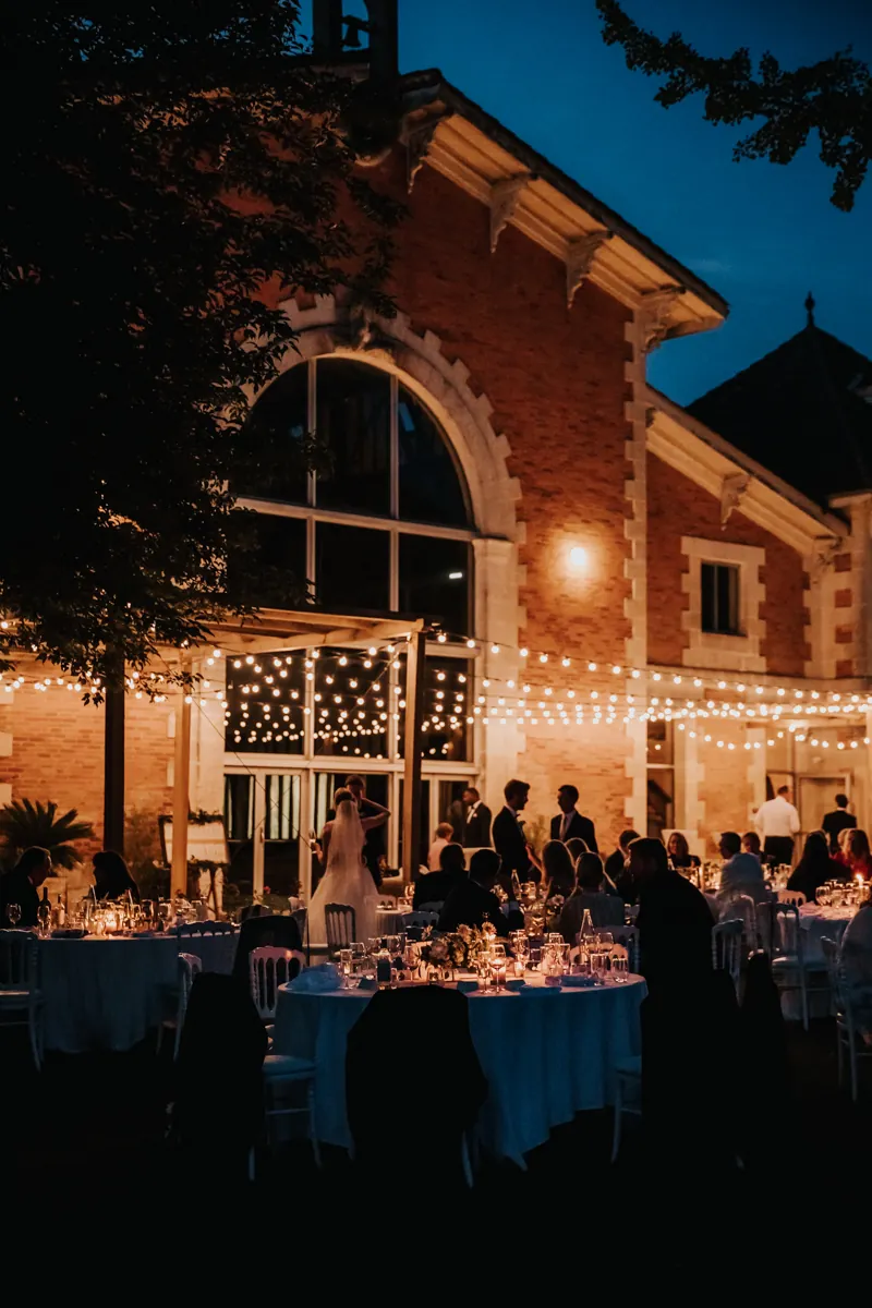 The reception hall lit for the evening, tables in blue