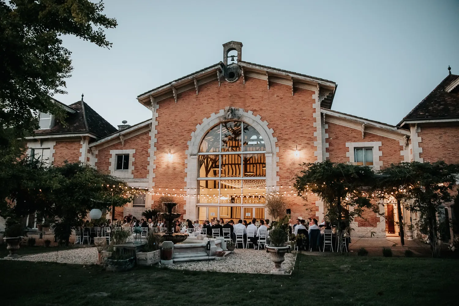 The brick façade of the reception hall lit at night